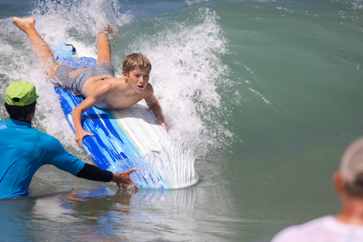 A grom learns board position, the hard way during the South Bay Boardriders Grom-O-Rama at 22nd Street in Hermosa Beach on Saturday, August 10. Photo by Wright Adaza