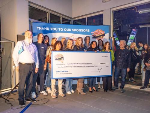 Manhattan Beach Education Foundation supporters accept a Skechers Pier to Pier Friendship check for $278,263.