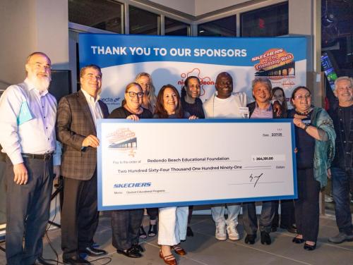 Redondo Beach Education Foundation supporters accept a Skechers Pier to Pier Friendship check for $265,191.