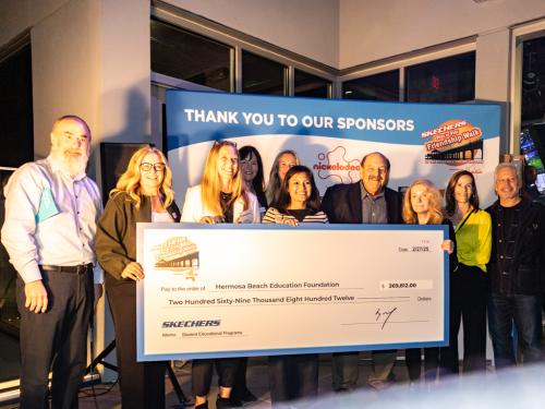 Hermosa Beach Education Foundation supporters accept a Skechers Pier to Pier Friendship check for $269,812.