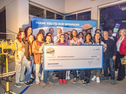 Friendship Foundation supporters accept a Skechers Pier to Pier Friendship check for $1,155,171.