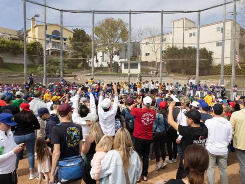 Players line up in front of the backstop